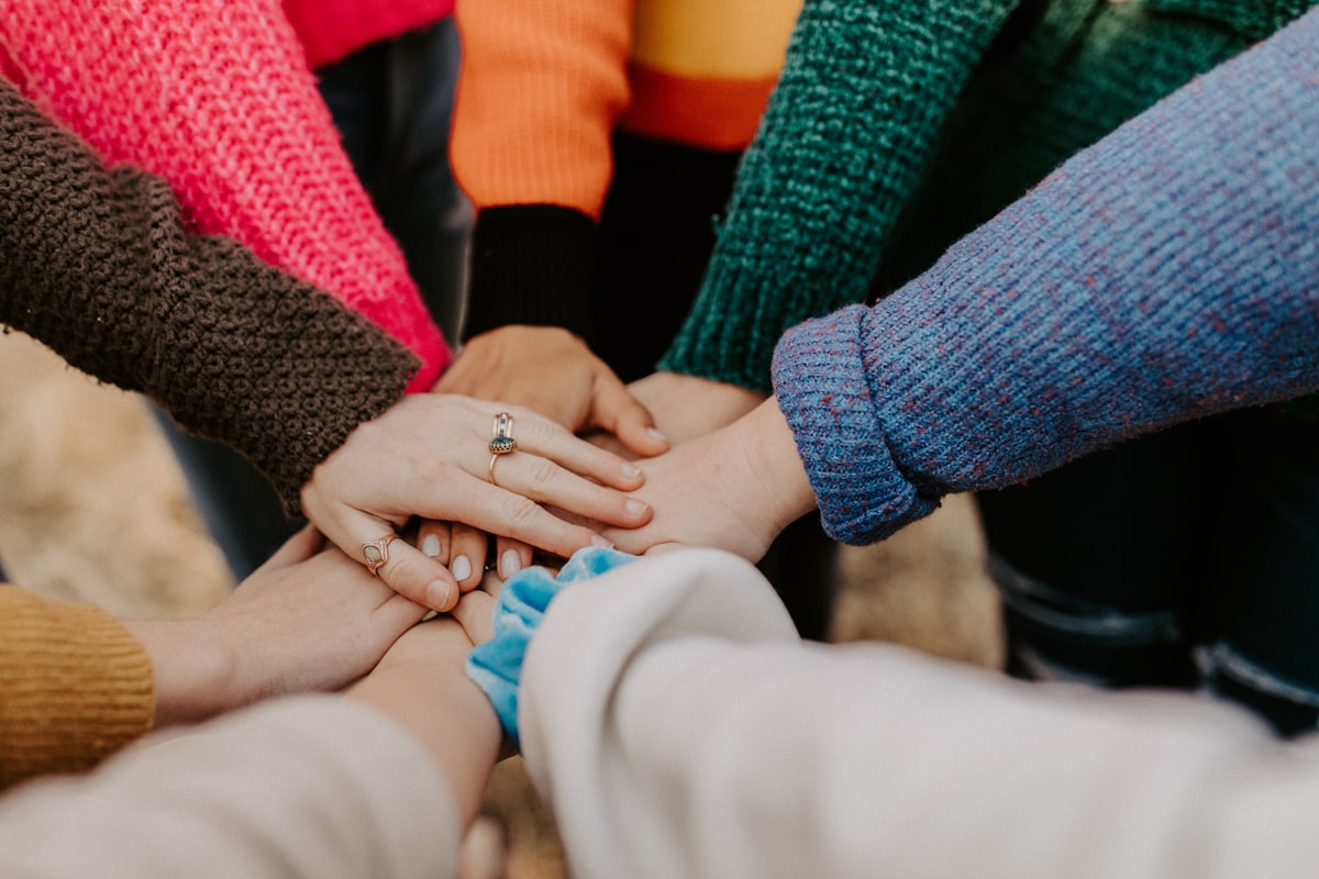 Hands joined in a community circle